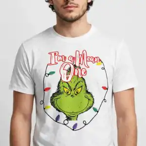 a green furry creature with yellow eyes and a mischievous expression, surrounded by Christmas lights and text design printed