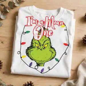 a green furry creature with yellow eyes and a mischievous expression, surrounded by Christmas lights and text design printed