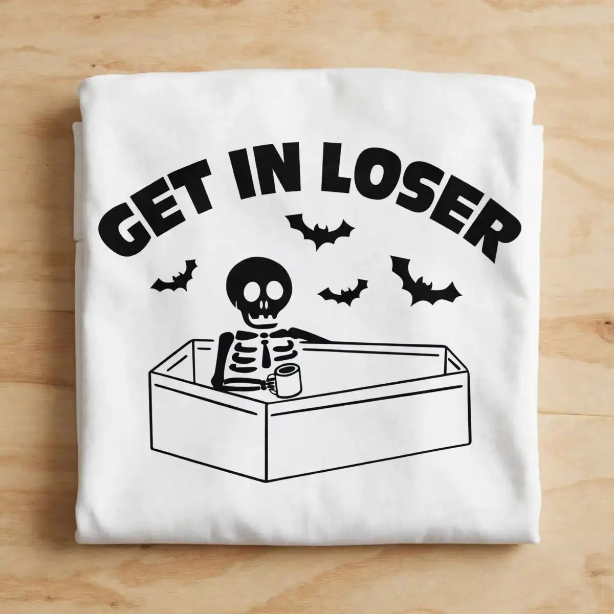 funny skeleton in coffin with get in loser text for halloween shirts skeleton get loser halloween svg design printed on a plain product mockup