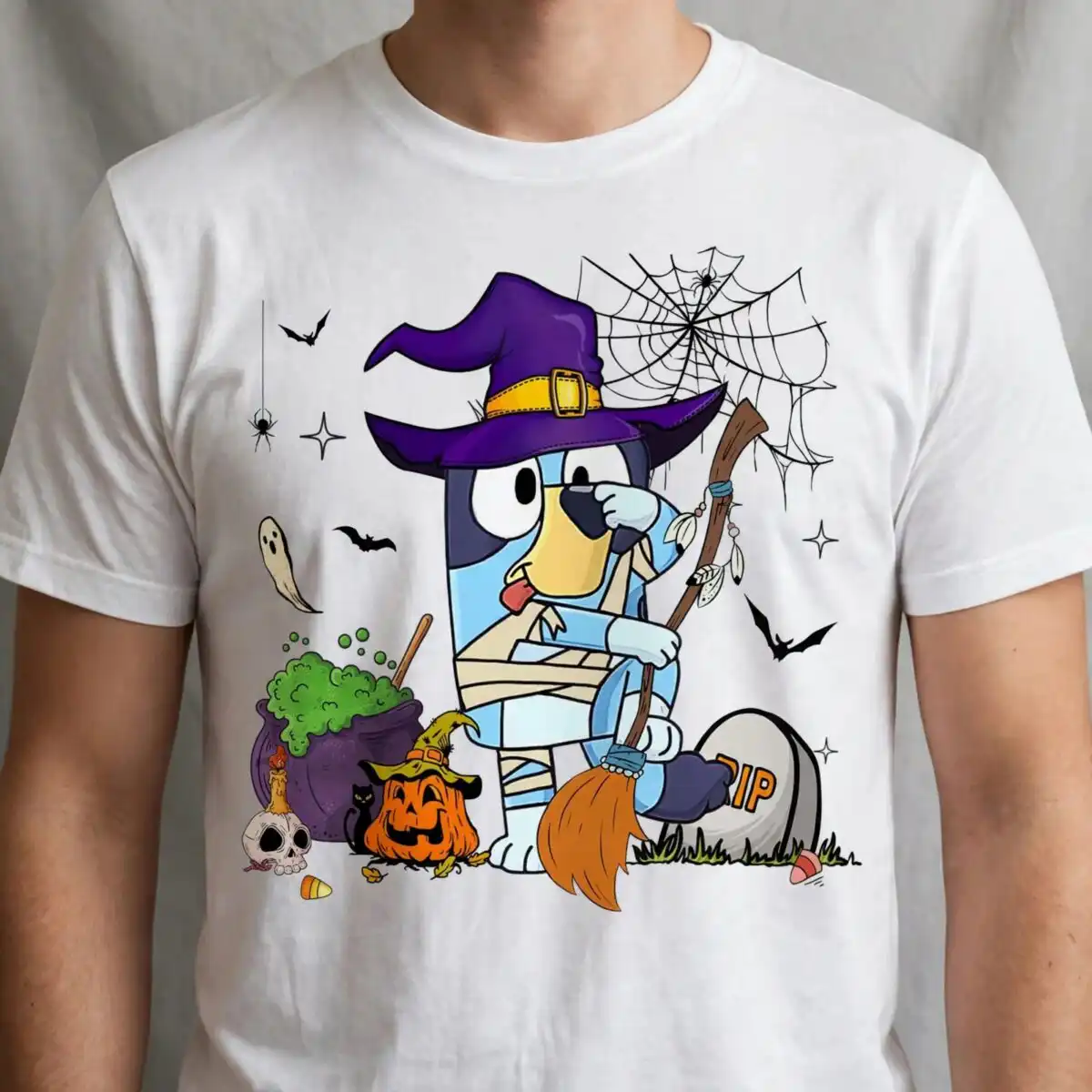 bluey heeler halloween witch dog with cauldron and pumpkin bluey heeler png design printed on a plain product mockup