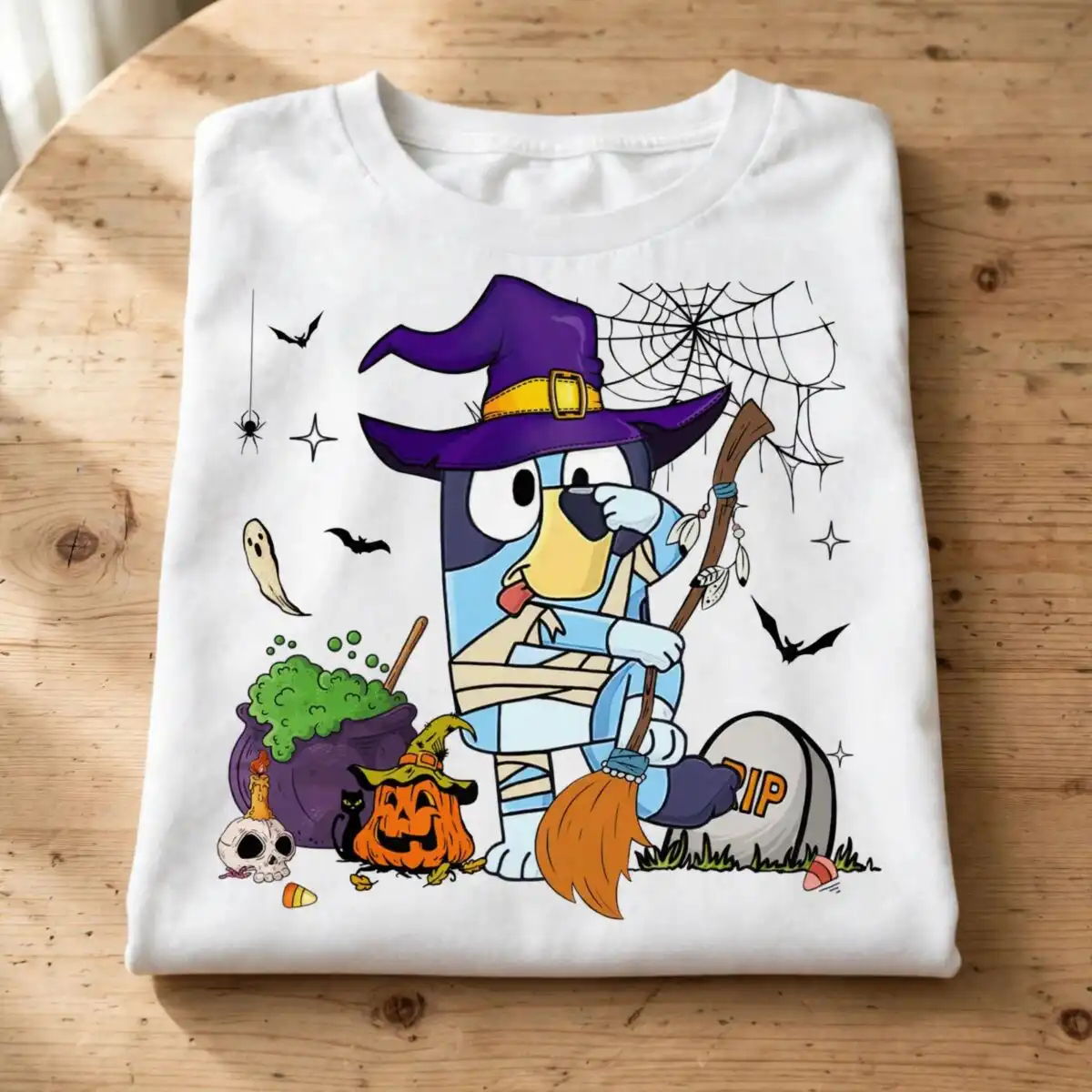 bluey heeler halloween witch dog with cauldron and pumpkin bluey heeler png design printed on a plain product mockup