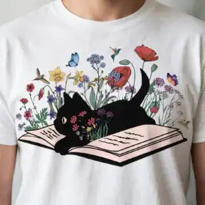 black cat lying on book with wildflowers png image for book lovers black cat png image design printed on a plain product mockup