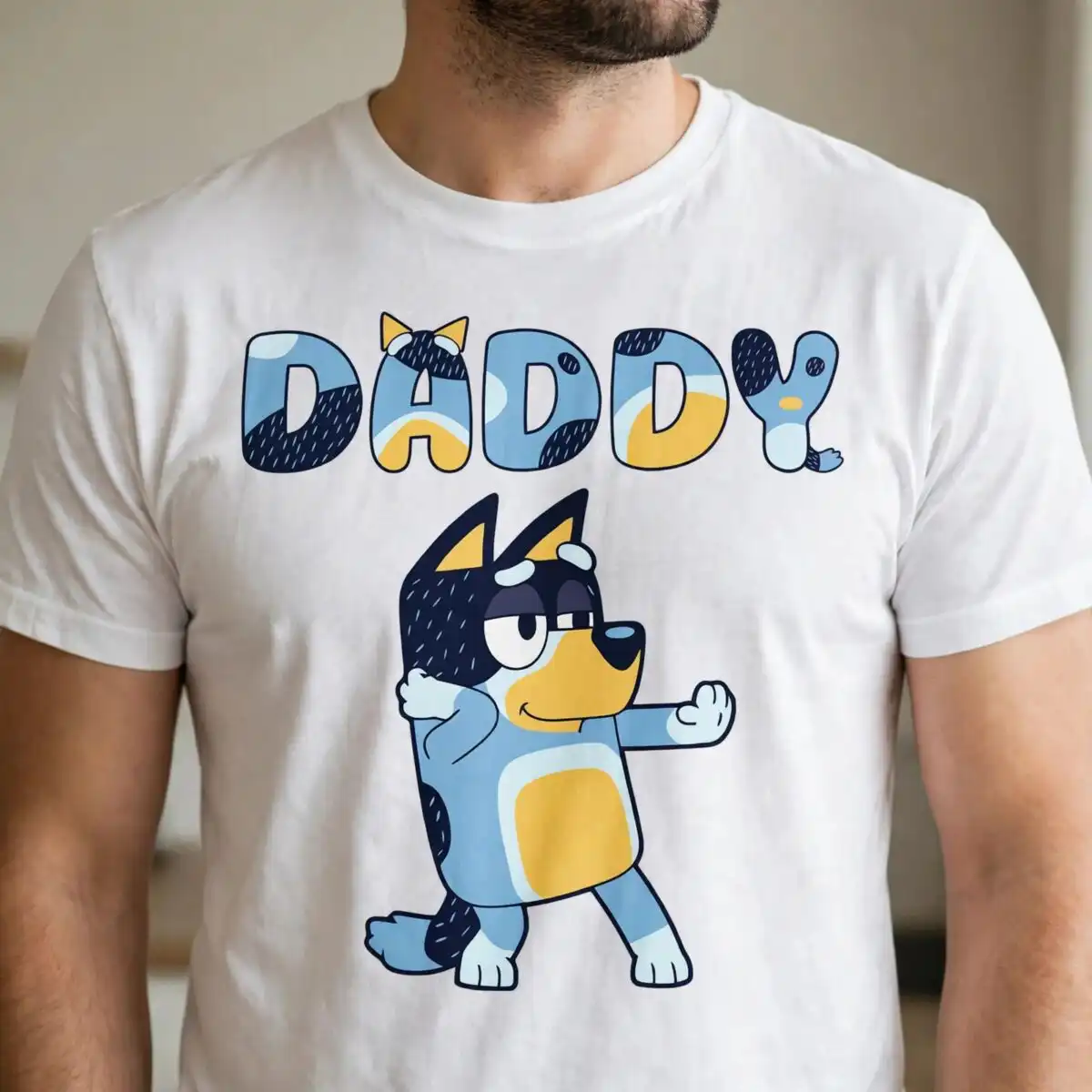 bluey daddy shirt design with dancing bandit dog and patterned daddy lettering bluey daddy bluey bandit svg design printed on a plain product mockup