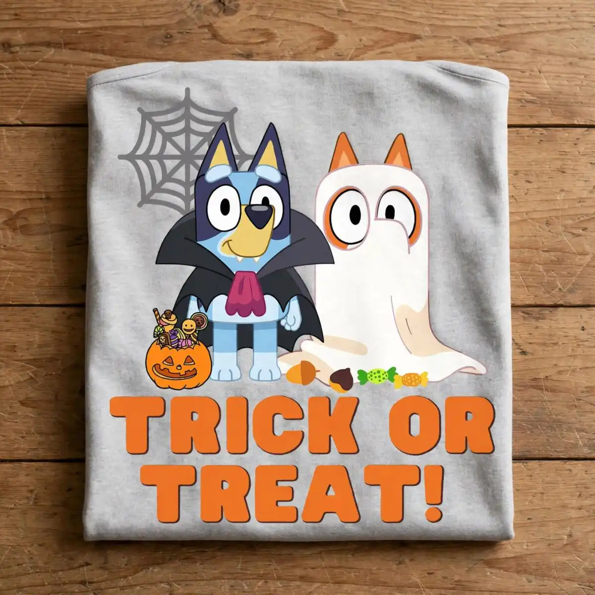 bluey and bingo trick or treat halloween shirt design for kids bluey bingo trick or shirt png design printed on a plain product mockup