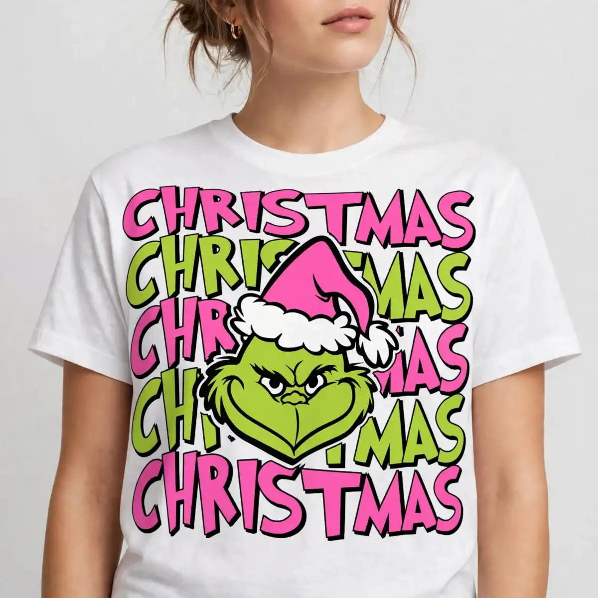a green furry face with a pink santa hat surrounded by the word Christmas design printed on a plain product mockup