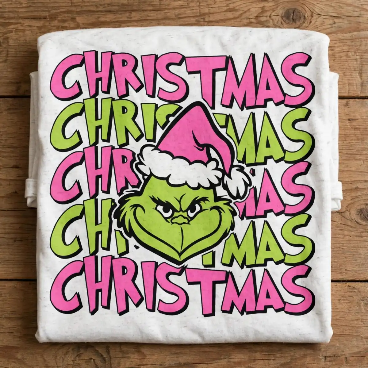 a green furry face with a pink santa hat surrounded by the word Christmas design printed on a plain product mockup