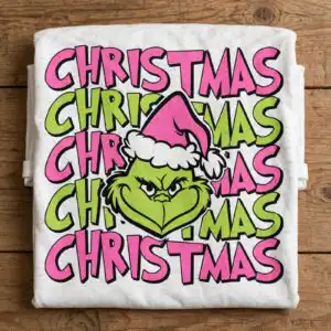 a green furry face with a pink santa hat surrounded by the word Christmas design printed on a plain product mockup