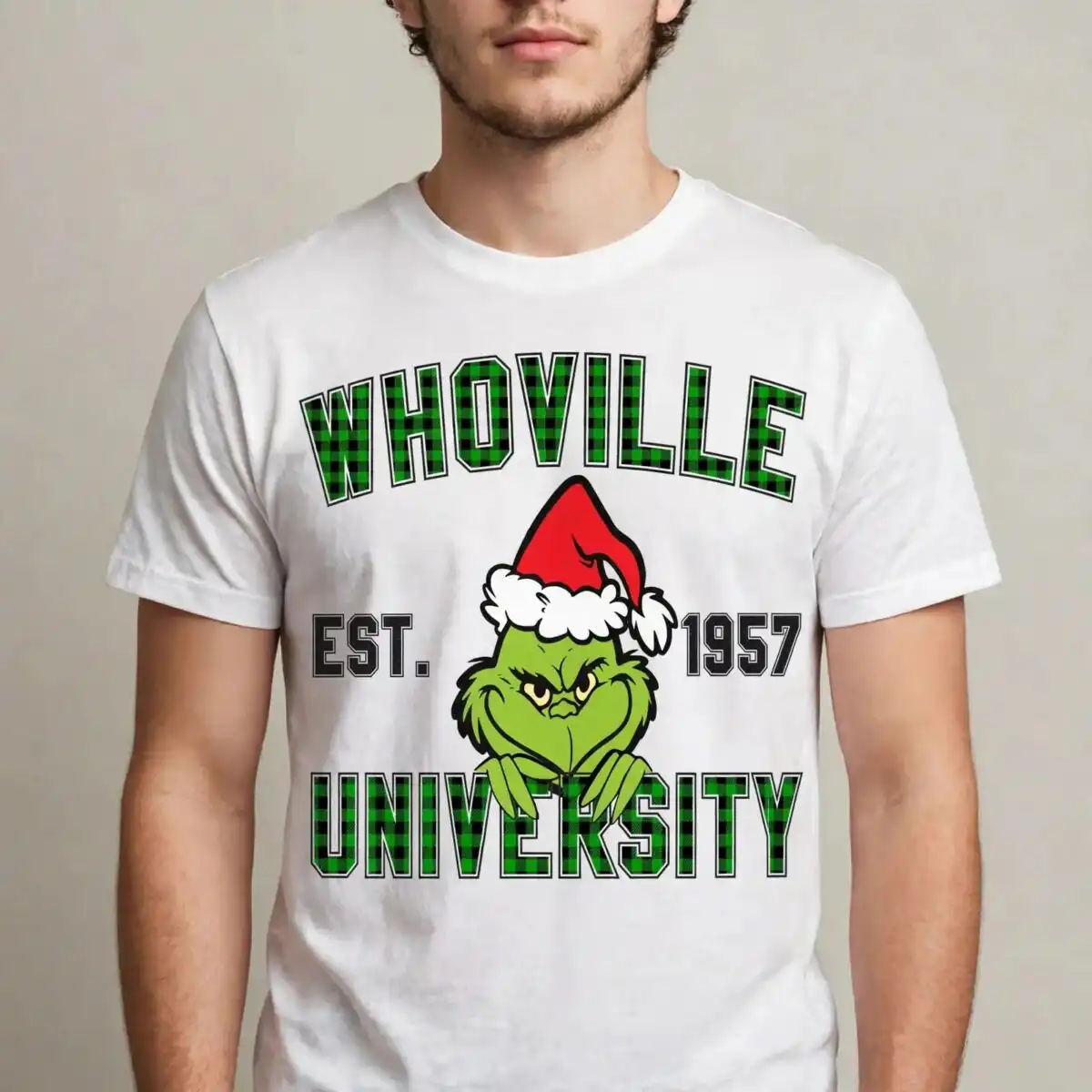 a green furry character wearing a Santa hat with text above and below design printed on a plain product mockup