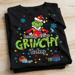 A green character in a Santa hat and suit, tangled in Christmas lights, with text and gift boxes. design printed on a plain p
