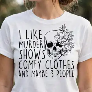 i like murder shows and comfy clothes floral skull halloween shirt design like murder shows comfy svg design printed on a plain product mockup