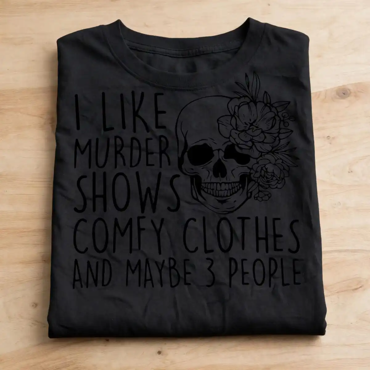 i like murder shows and comfy clothes floral skull halloween shirt design like murder shows comfy svg design printed on a plain product mockup