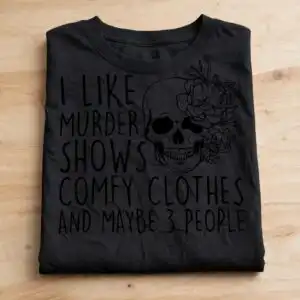 i like murder shows and comfy clothes floral skull halloween shirt design like murder shows comfy svg design printed on a plain product mockup