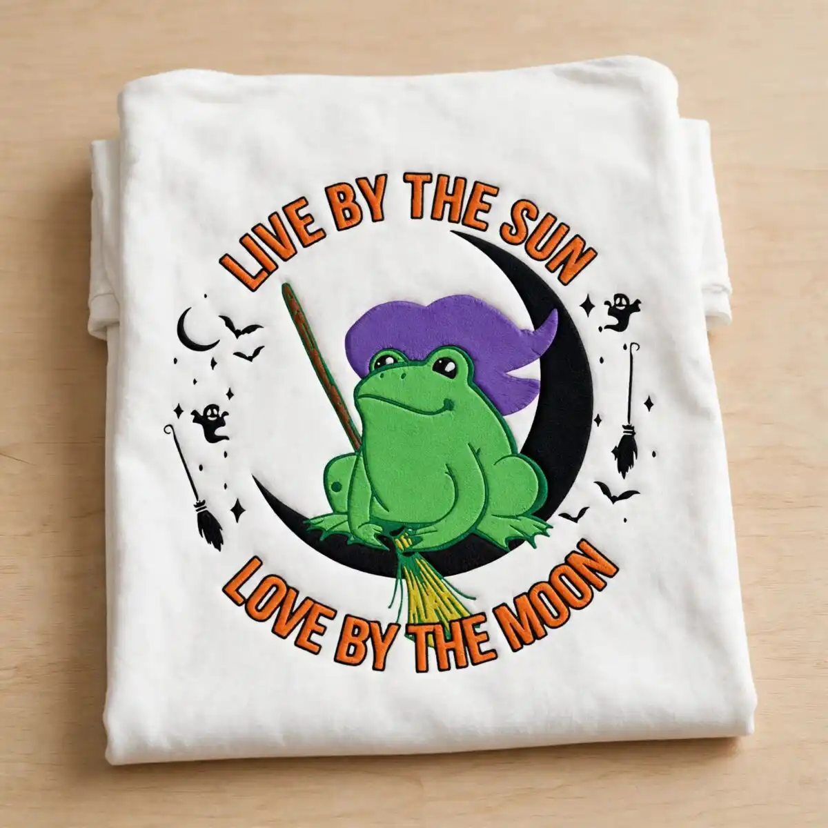 live by the sun love by the moon halloween frog witch shirt design live by the sun love by the moon svg design printed on a plain product mockup