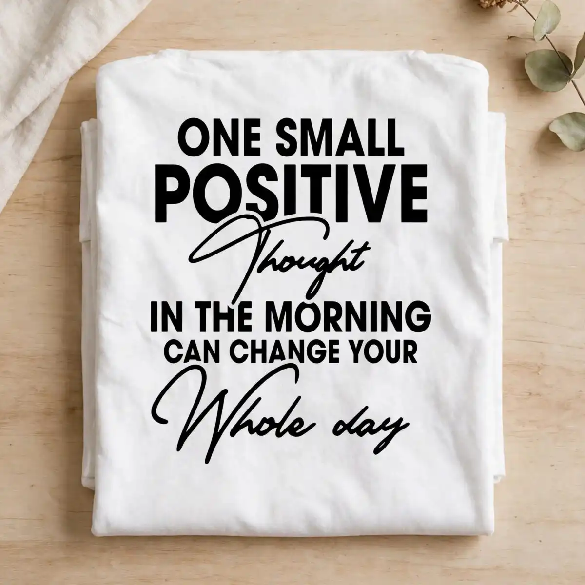 motivational quote lettering design: one small positive thought in black block and script motivational quote svg design printed on a plain product mockup
