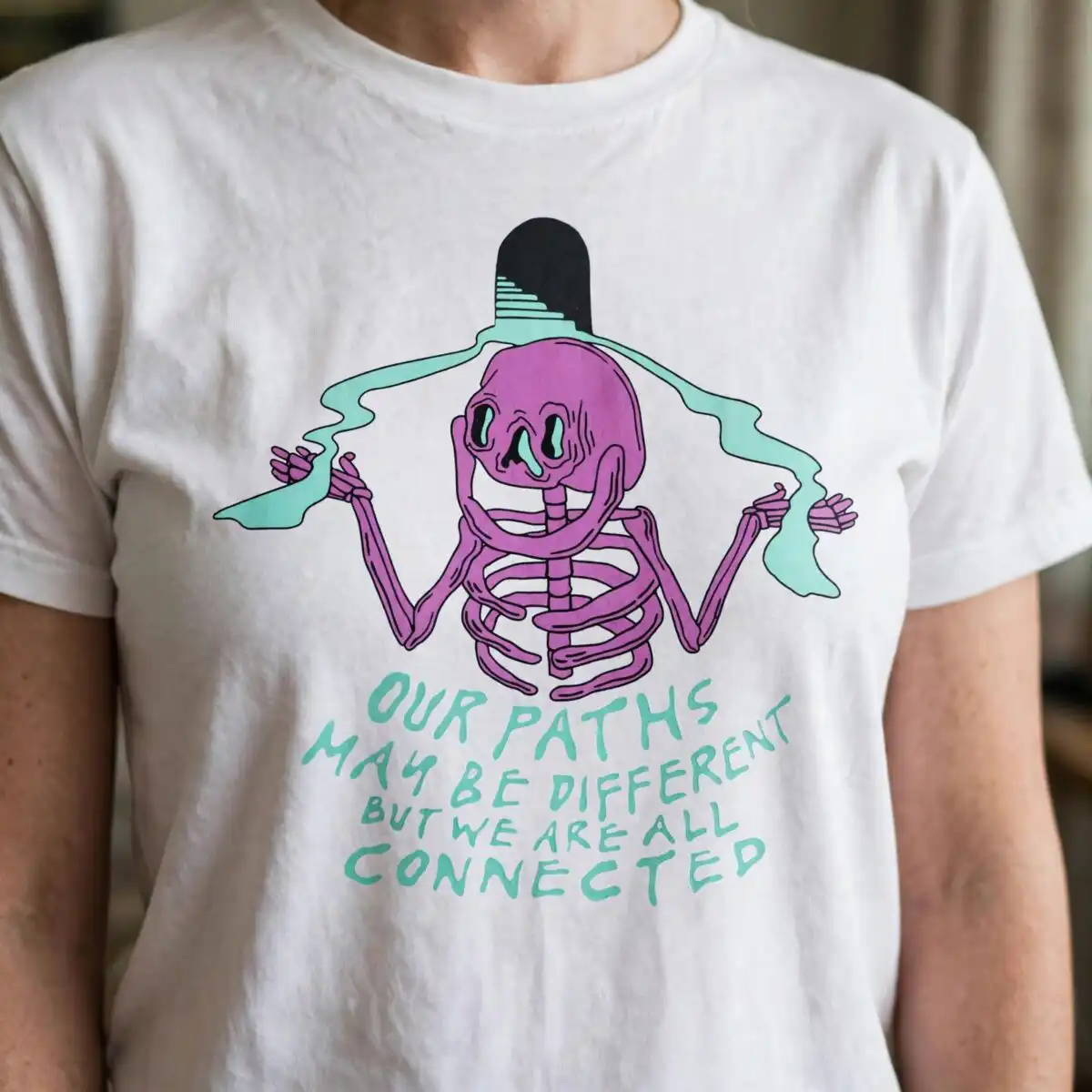 skeleton line art shirt design: arms raised quote with mint green ribbon, svg and png skeleton line art png design printed on a plain product mockup
