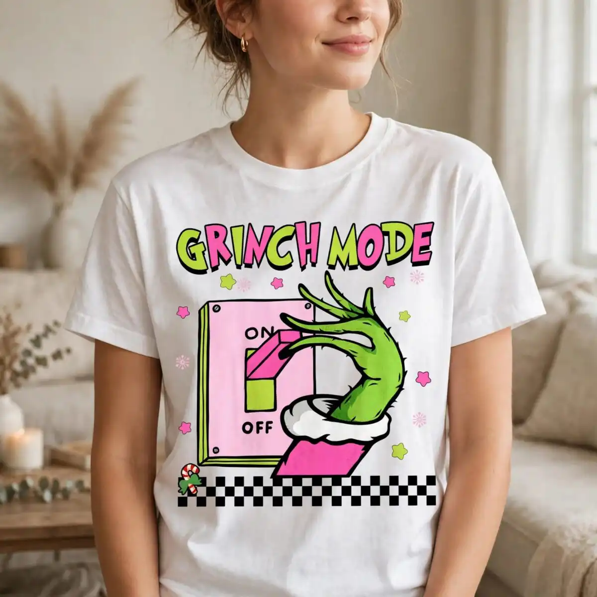 pink grinch mode on off toggle with hairy green hand design A green, hairy hand with long fingers pushing a pink and green switch on a light pink panel, with text and decorative element
