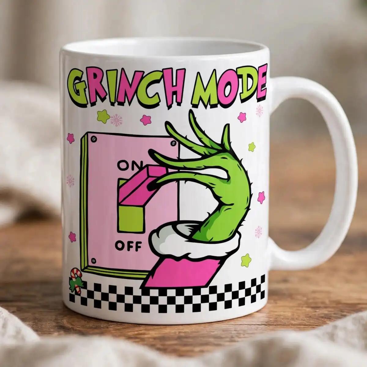 pink grinch mode on off toggle with hairy green hand design A green, hairy hand with long fingers pushing a pink and green switch on a light pink panel, with text and decorative element