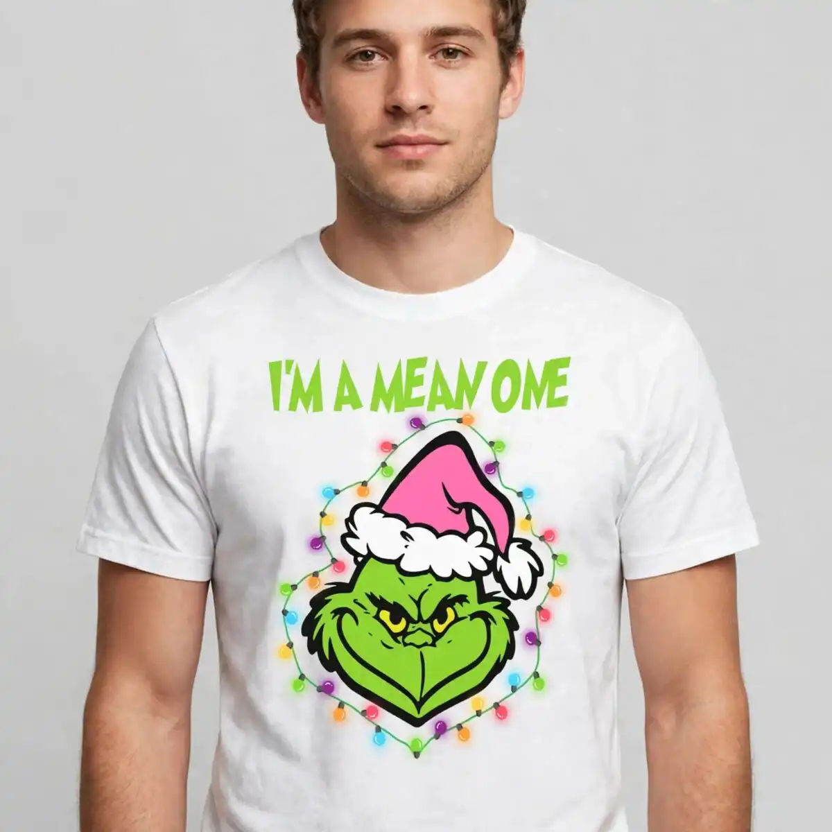 A green character's face wearing a pink Santa hat, surrounded by Christmas lights. design printed on a plain product mockup