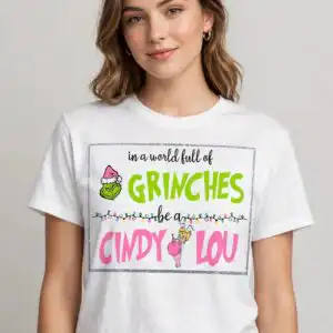 a quote about being kind with a green character wearing a Santa hat and a small girl holding an ornament, framed by glitter d