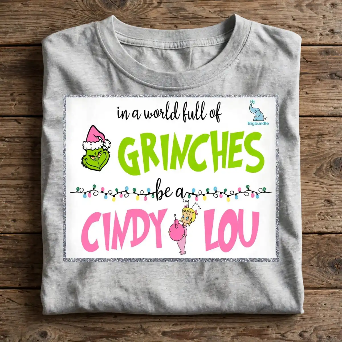a quote about being kind with a green character wearing a Santa hat and a small girl holding an ornament, framed by glitter d