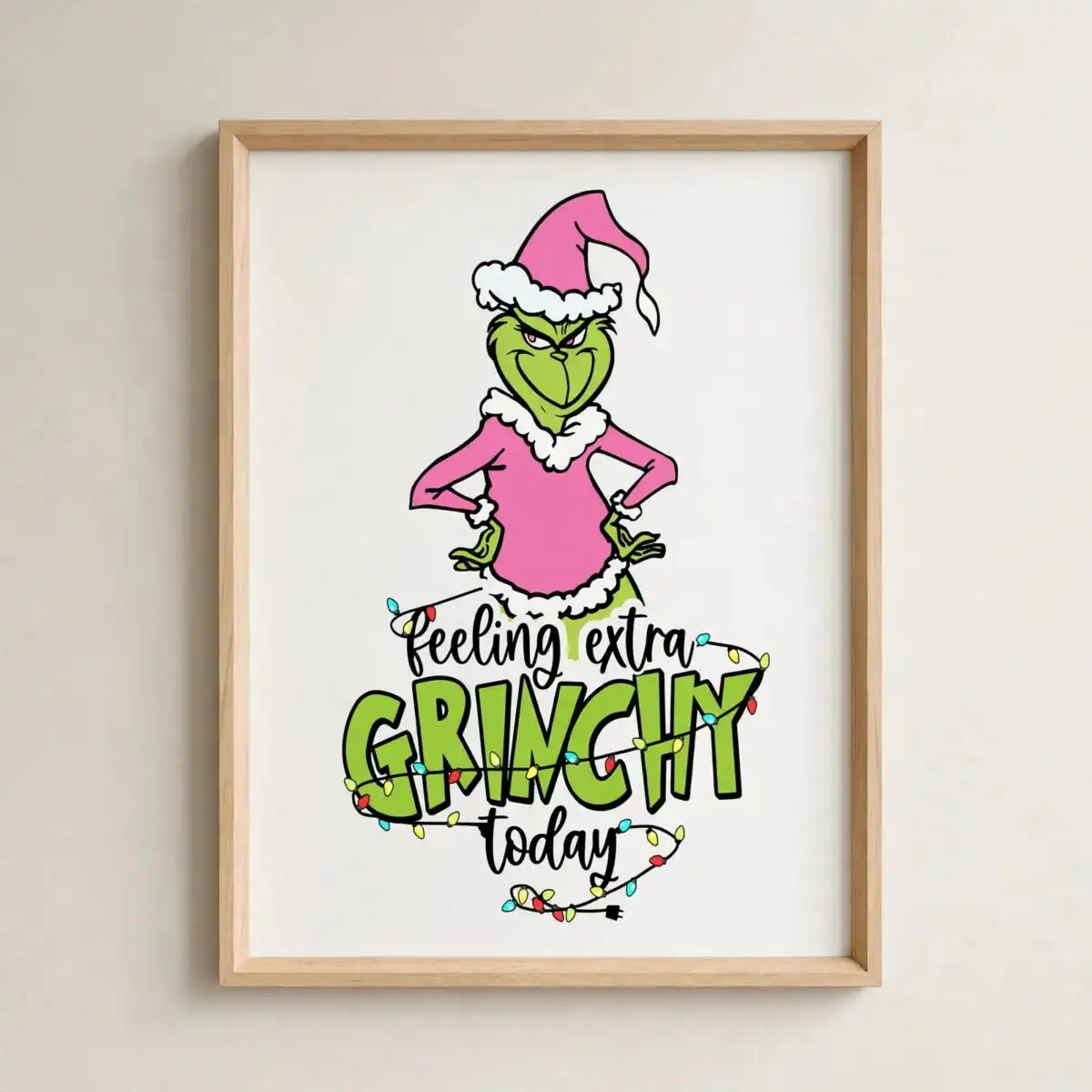 feeling extra grinchy today grinch svg - pink grinchmas design A green character with a pink Santa hat and outfit, surrounded by Christmas lights and text. design printed on a plain produc