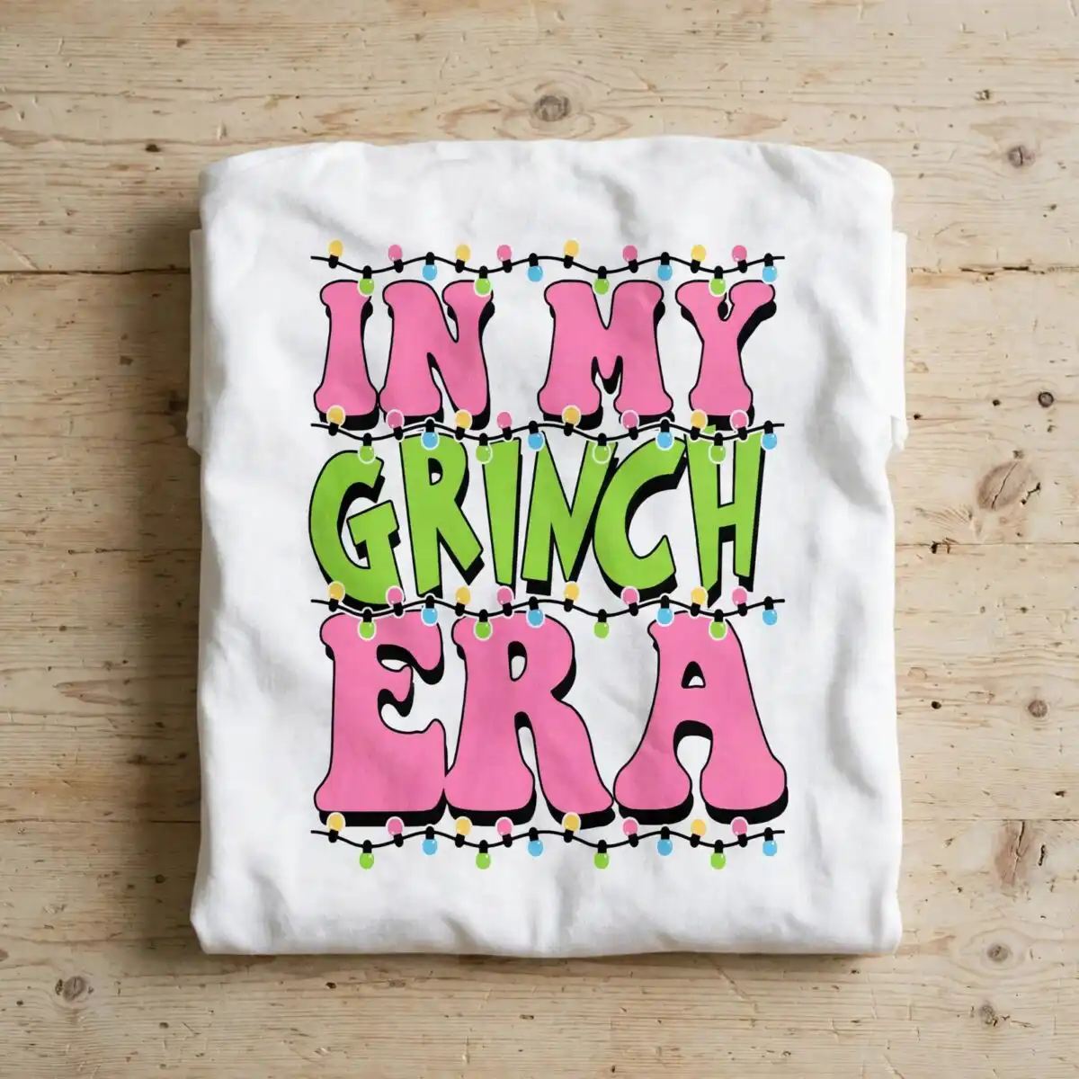 in my grinch era svg with christmas lights quote design text with Christmas lights design printed on a plain product mockup